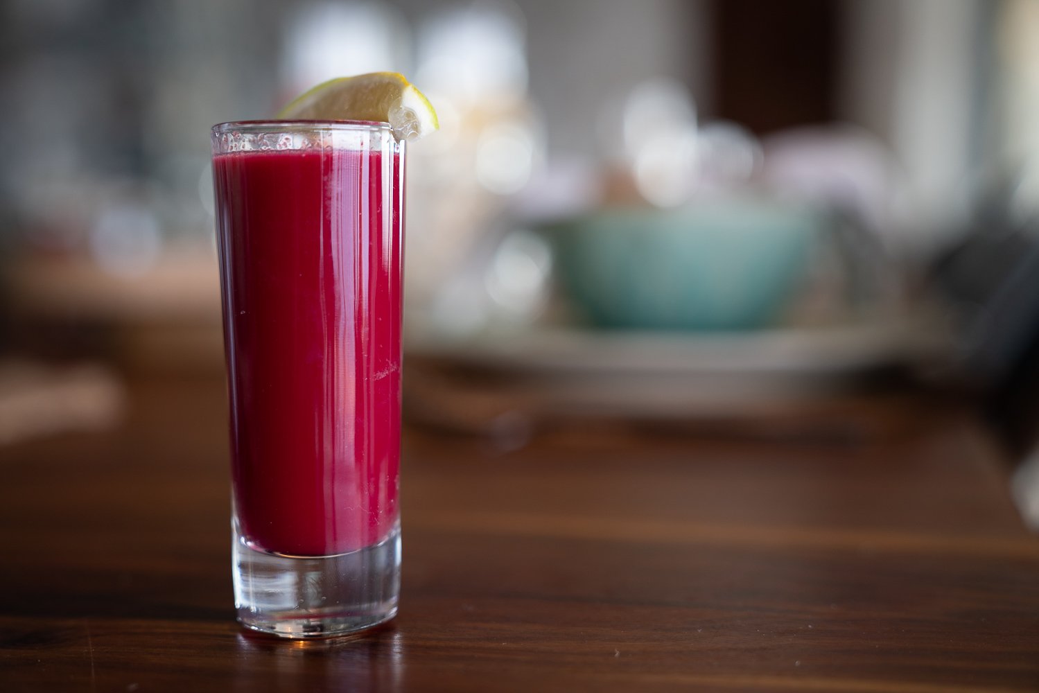 Red juice shot on a wooden table at The Aerial BVI