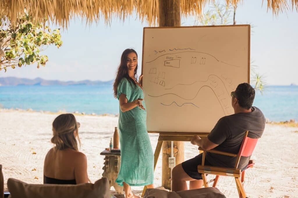 woman drawing an illustration on a board