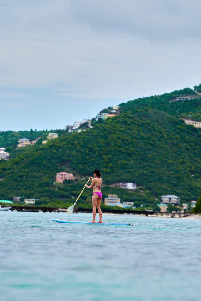 woman standup paddleboarding in BVI at the Little Jost Van Dyke