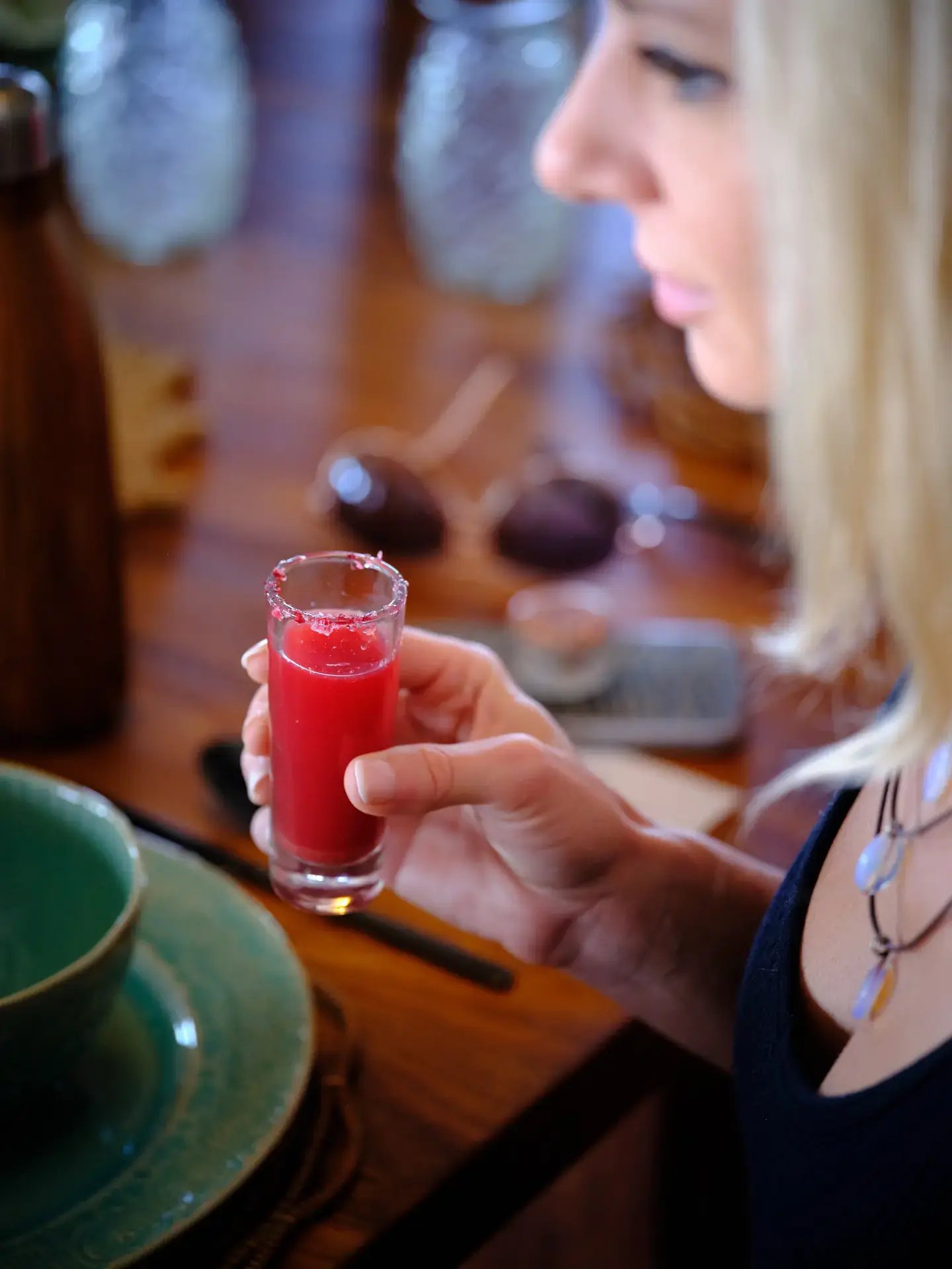 Guest enjoying a drink at the table at The Aerial BVI