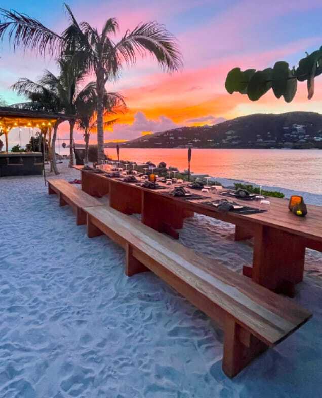 Outdoor dining table set up at sunset at The Aerial, BVI