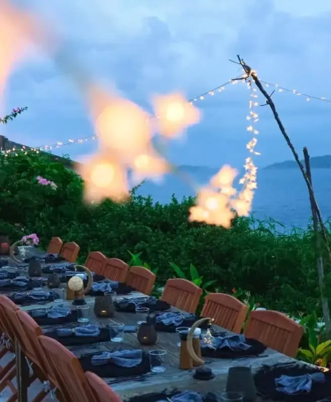 Outdoor dinner table set up in the evening at HEAL Retreat, The Aerial, BVI