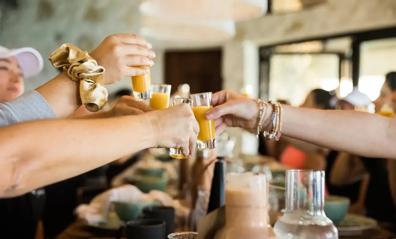 Guests toasting drinks together at HEAL Retreat, The Aerial, BVI