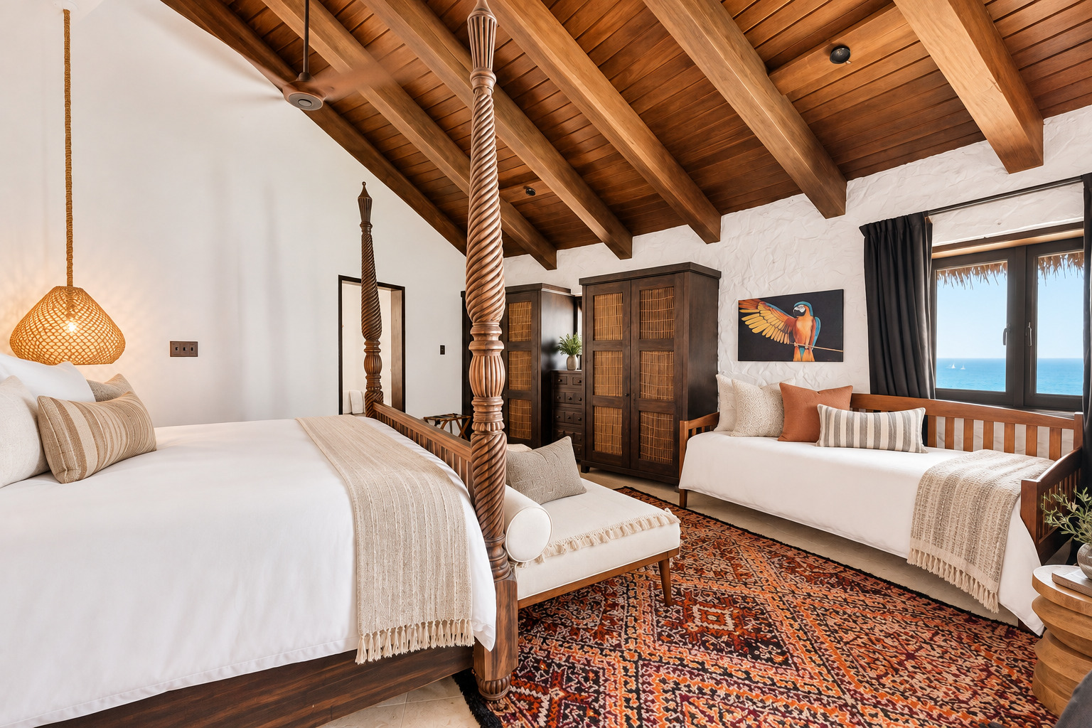 Twin four-poster beds with parrot artwork at The Aerial, BVI