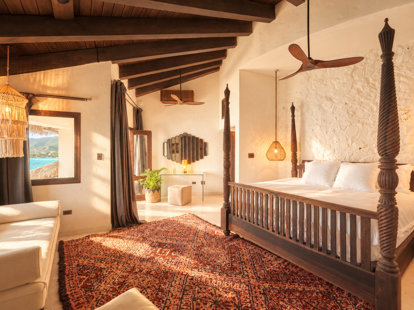 Four-poster bed and lounge seating with ocean-view window at The Aerial, BVI
