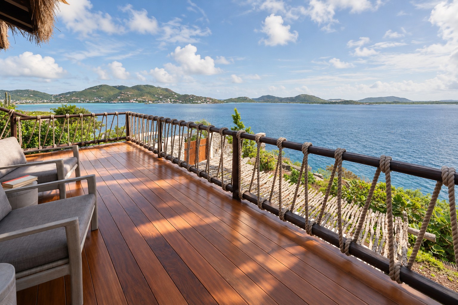 Deck with rope railing overlooking the bay and mountains.