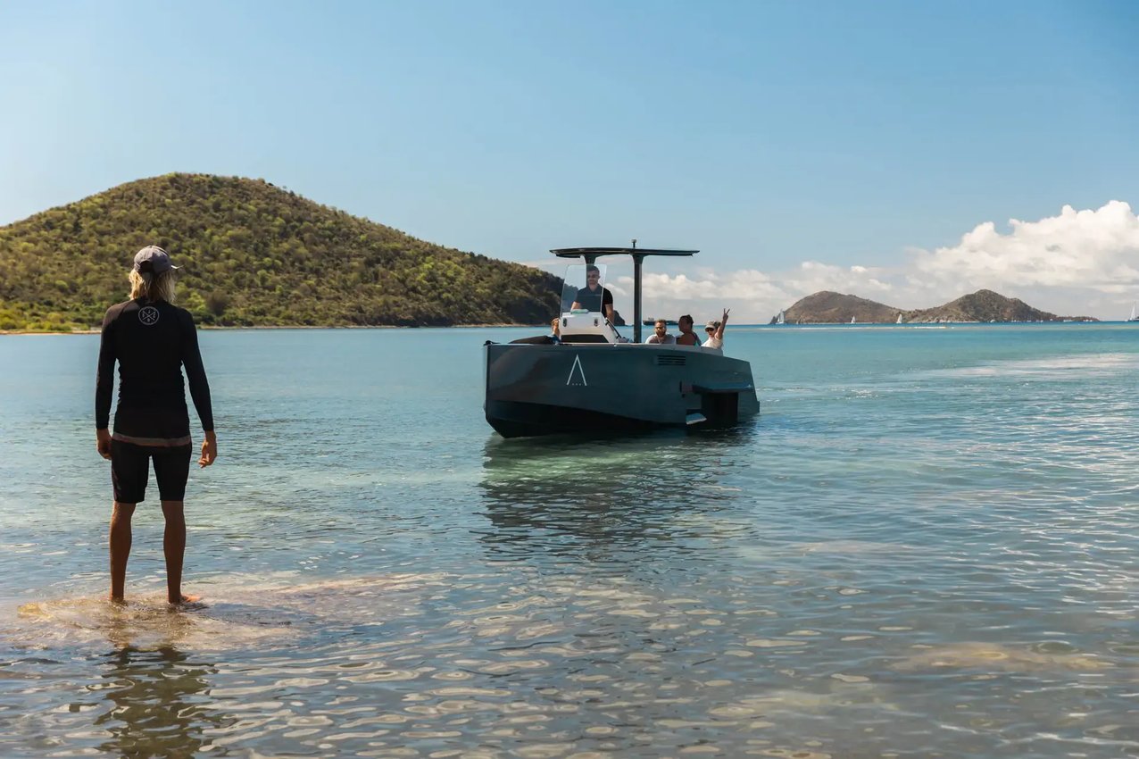 Team member welcoming guests arriving by boat at The Aerial, BVI