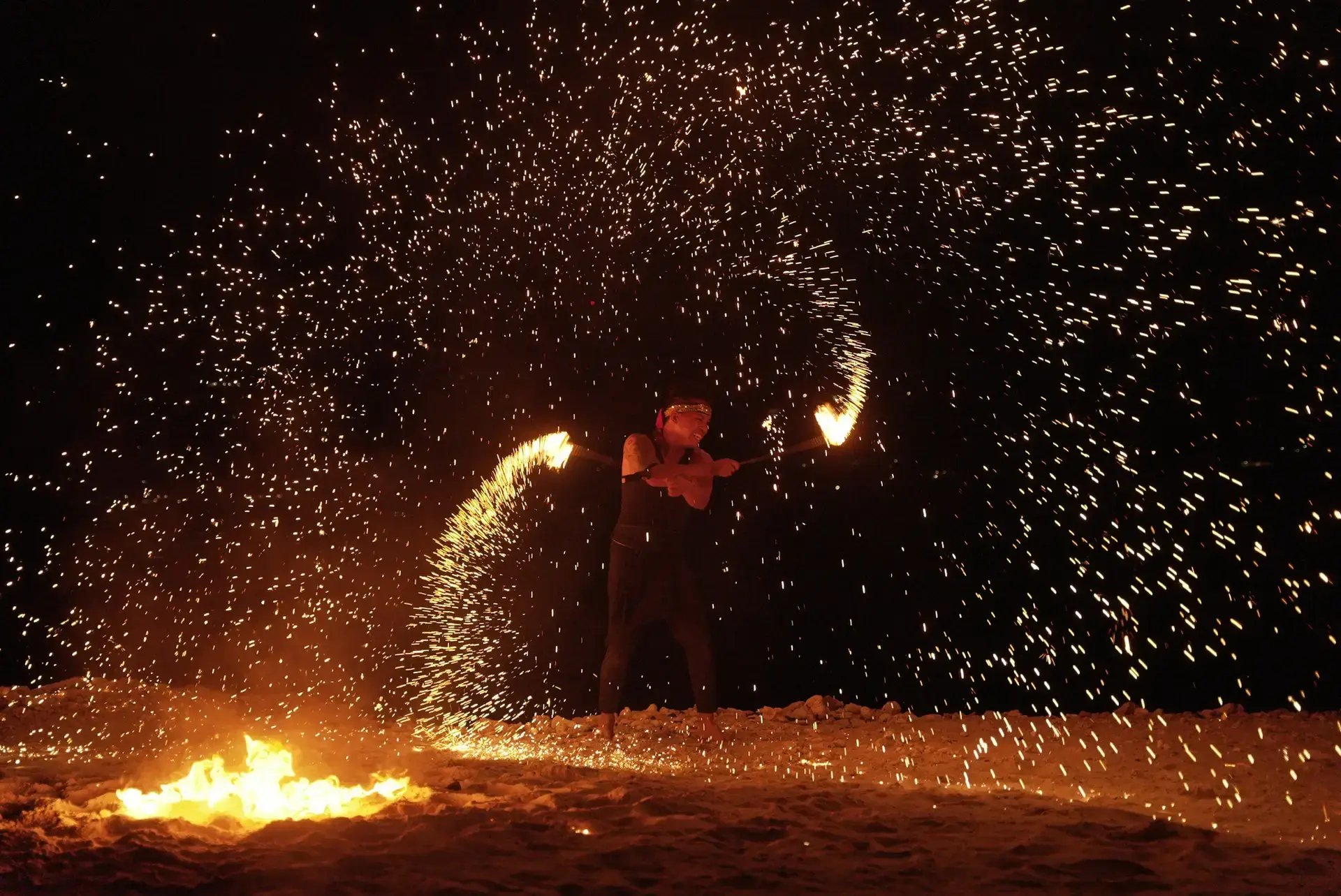 Fire dancer performing on the beach at night at The Aerial, BVI
