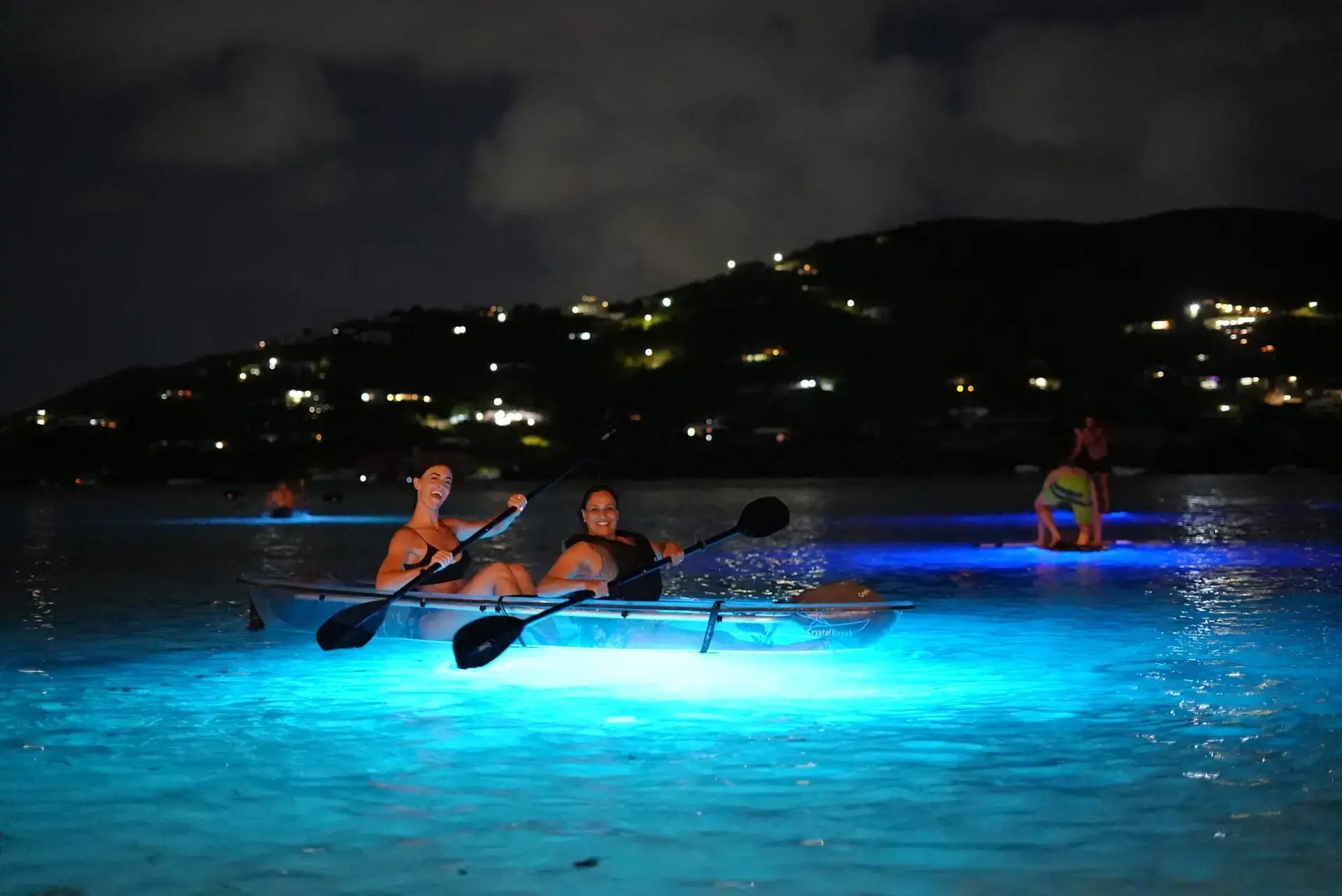 Guests glow-in-the-dark paddleboarding at night at The Aerial, BVI.
