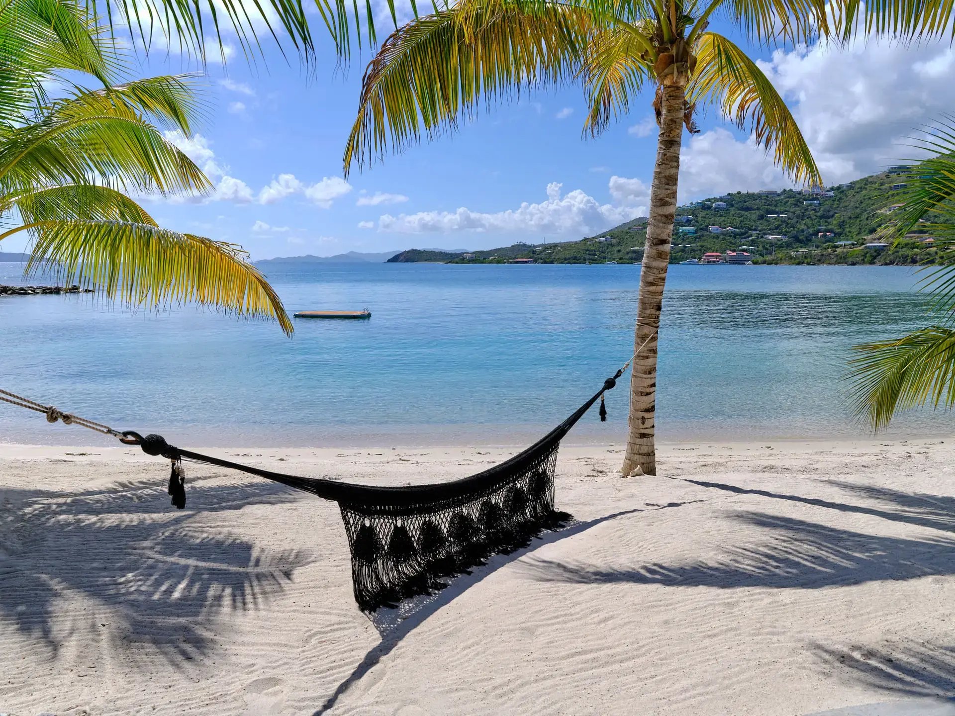 Hammock between palm trees on the beach at The Aerial, BVI.