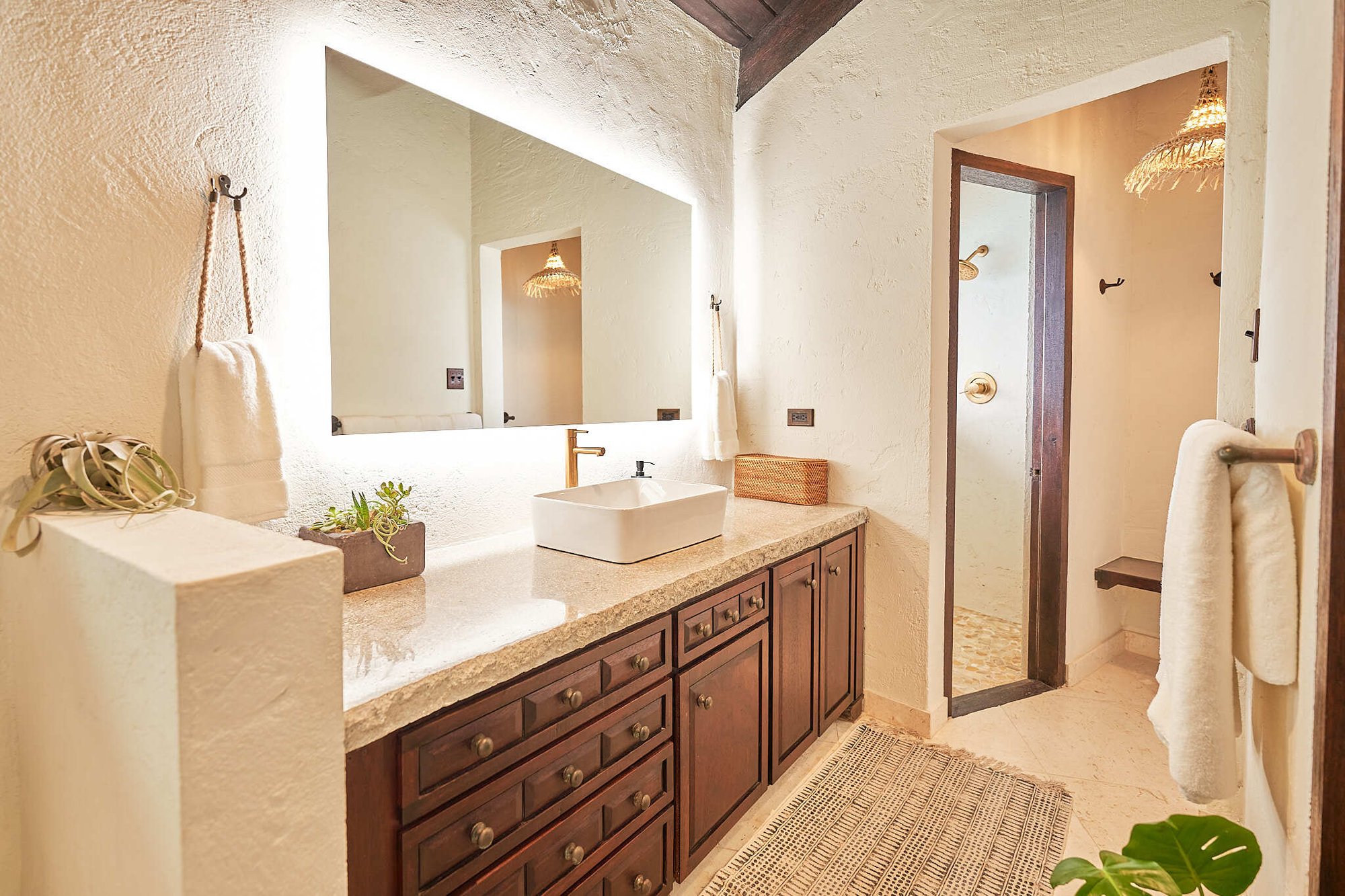 Bathroom vanity with backlit mirror and walk-in shower at The Aerial, BVI