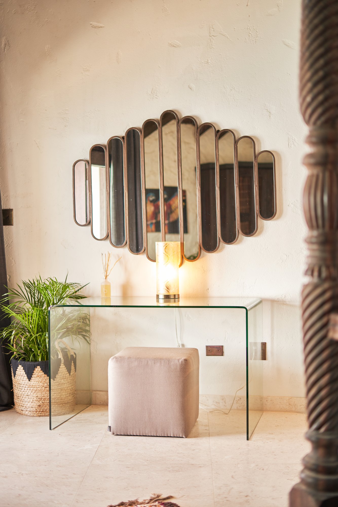 Entryway with fan-shaped mirror and glass console table at The Aerial, BVI