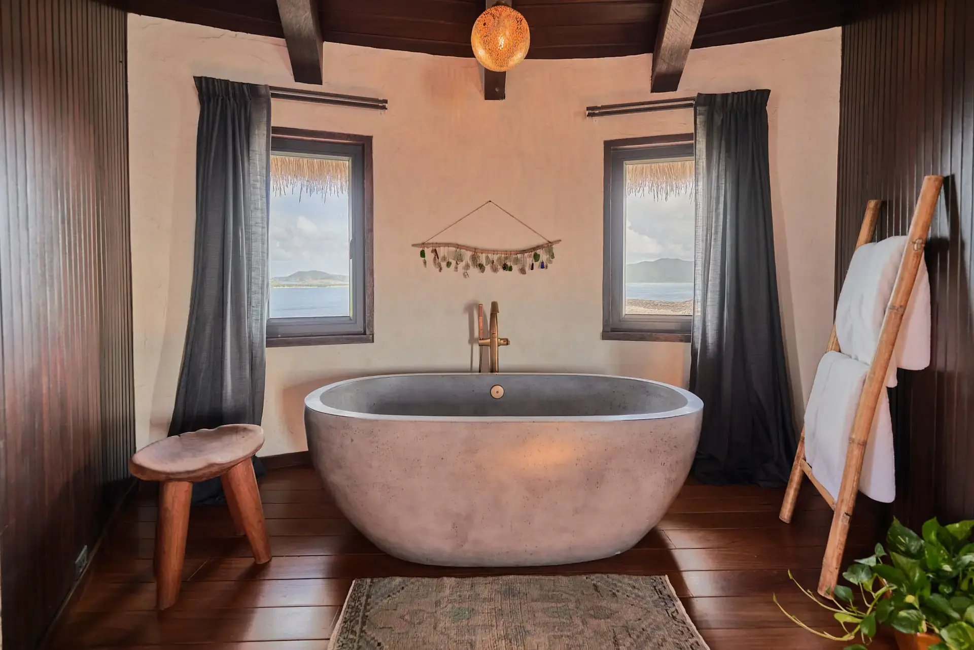 Freestanding tub between two ocean-view windows at The Aerial, BVI