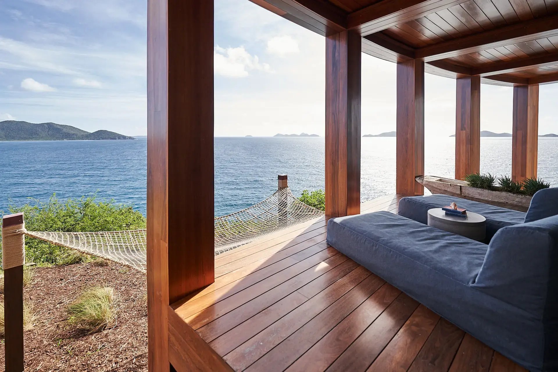 Covered deck lounge with hammock net and ocean view at The Aerial, BVI