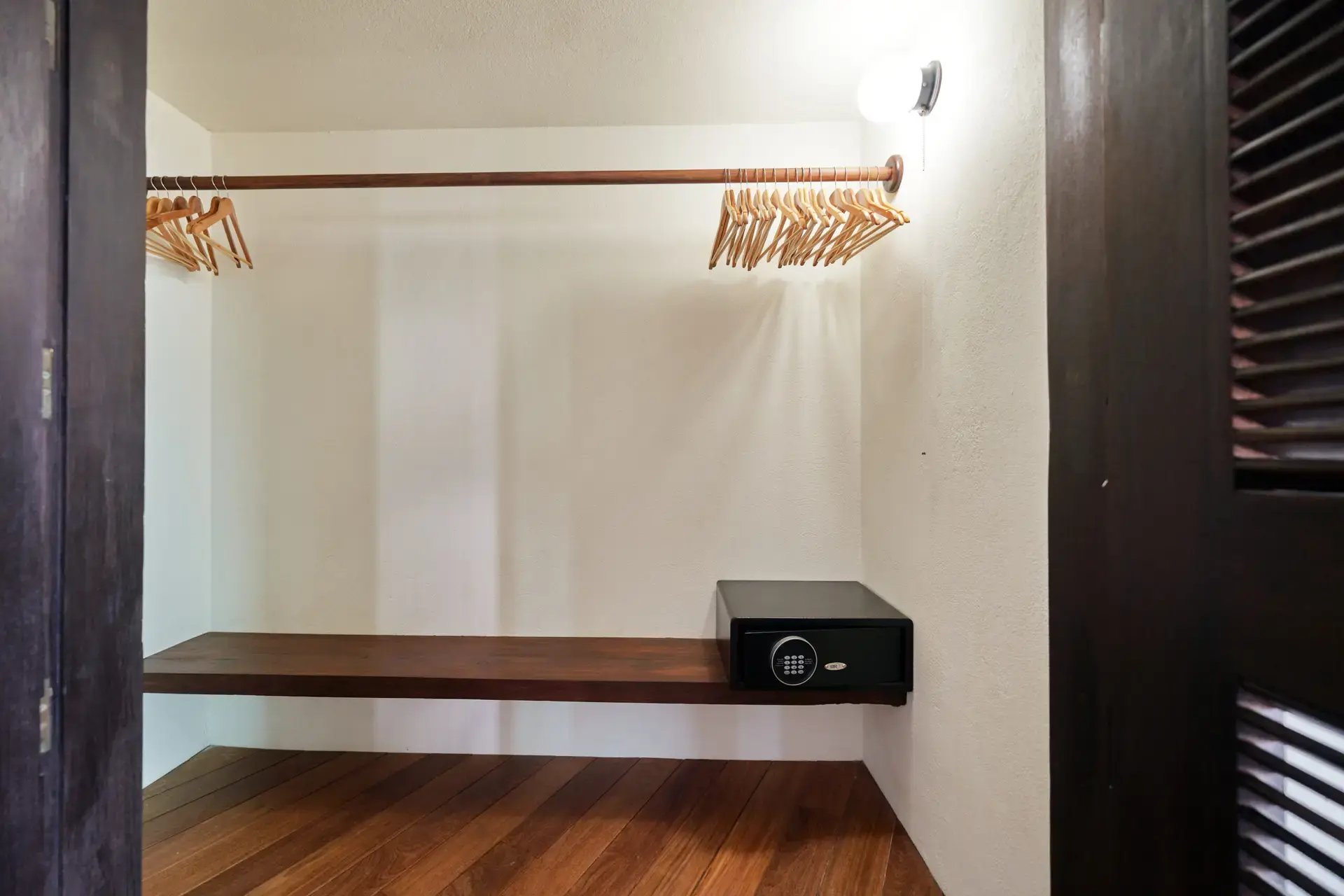 Closet nook with hanging rod and floating safe shelf.