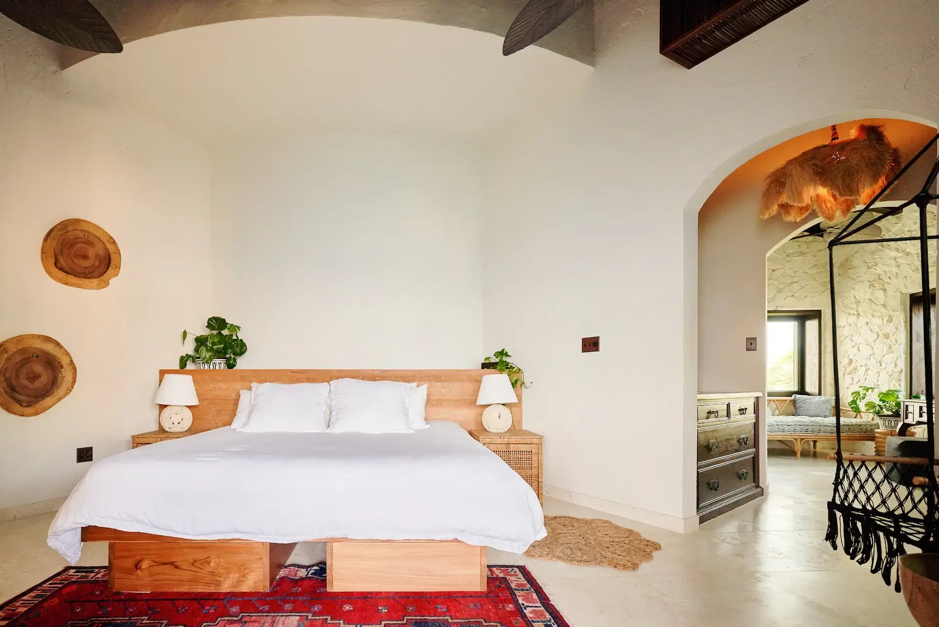King bed with hanging chair and lounge area at The Aerial, BVI
