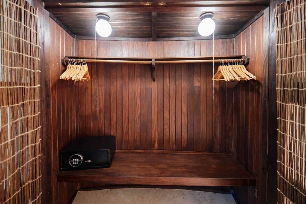 Wooden closet with hangers and in-room safe at The Aerial, BVI