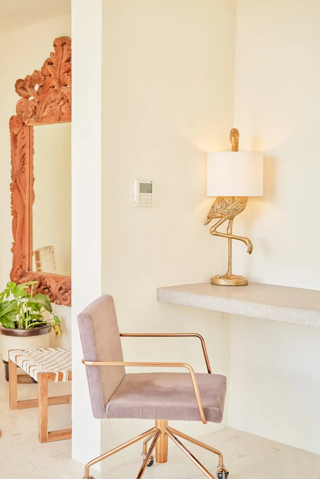 Reading nook with vanity mirror and gold accent chair.