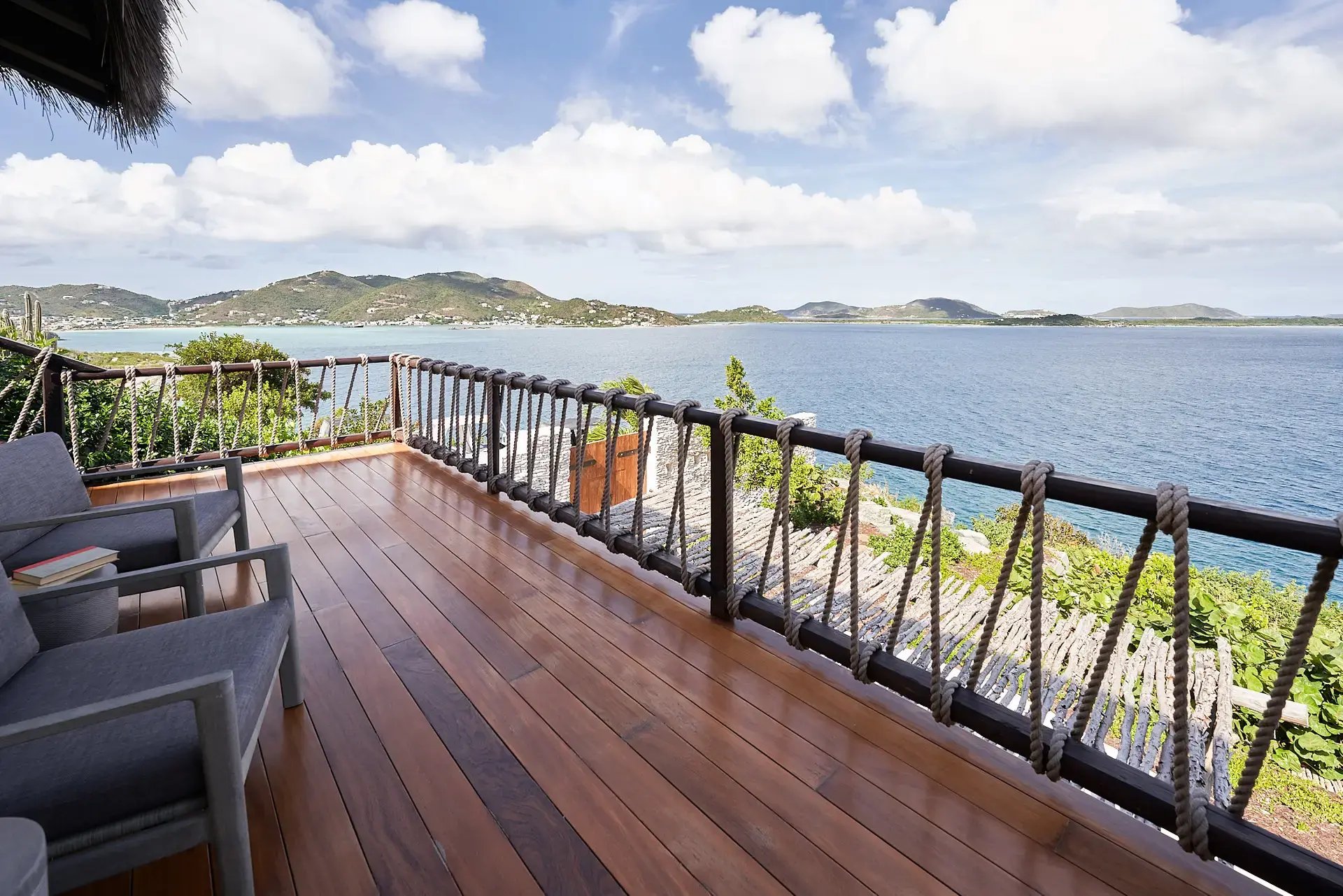 Deck with rope railing overlooking the bay and mountains.