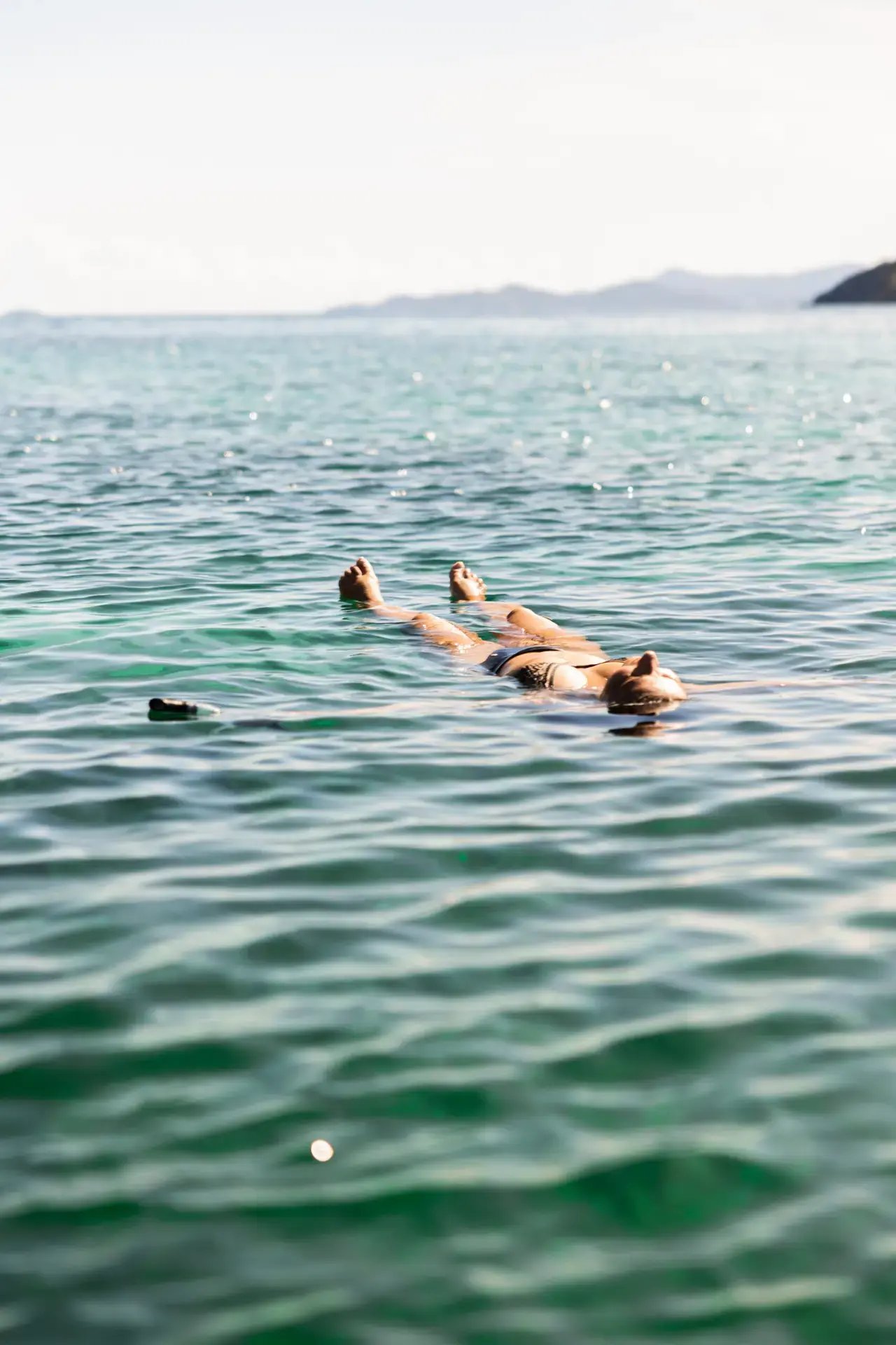 Guest floating on their back in the open water at The Aerial, BVI
