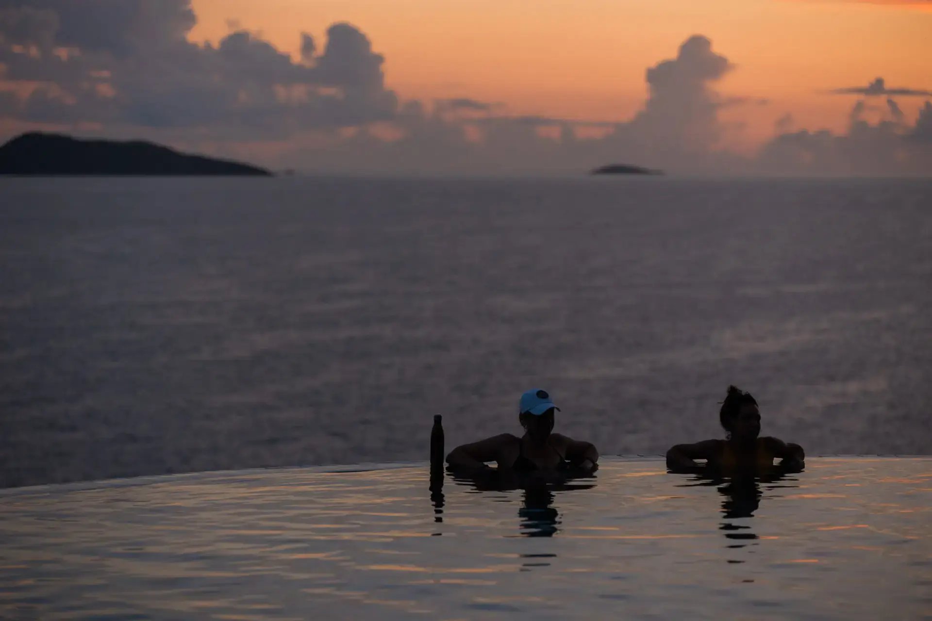 Guests relaxing in the infinity pool at sunset at The Aerial, BVI