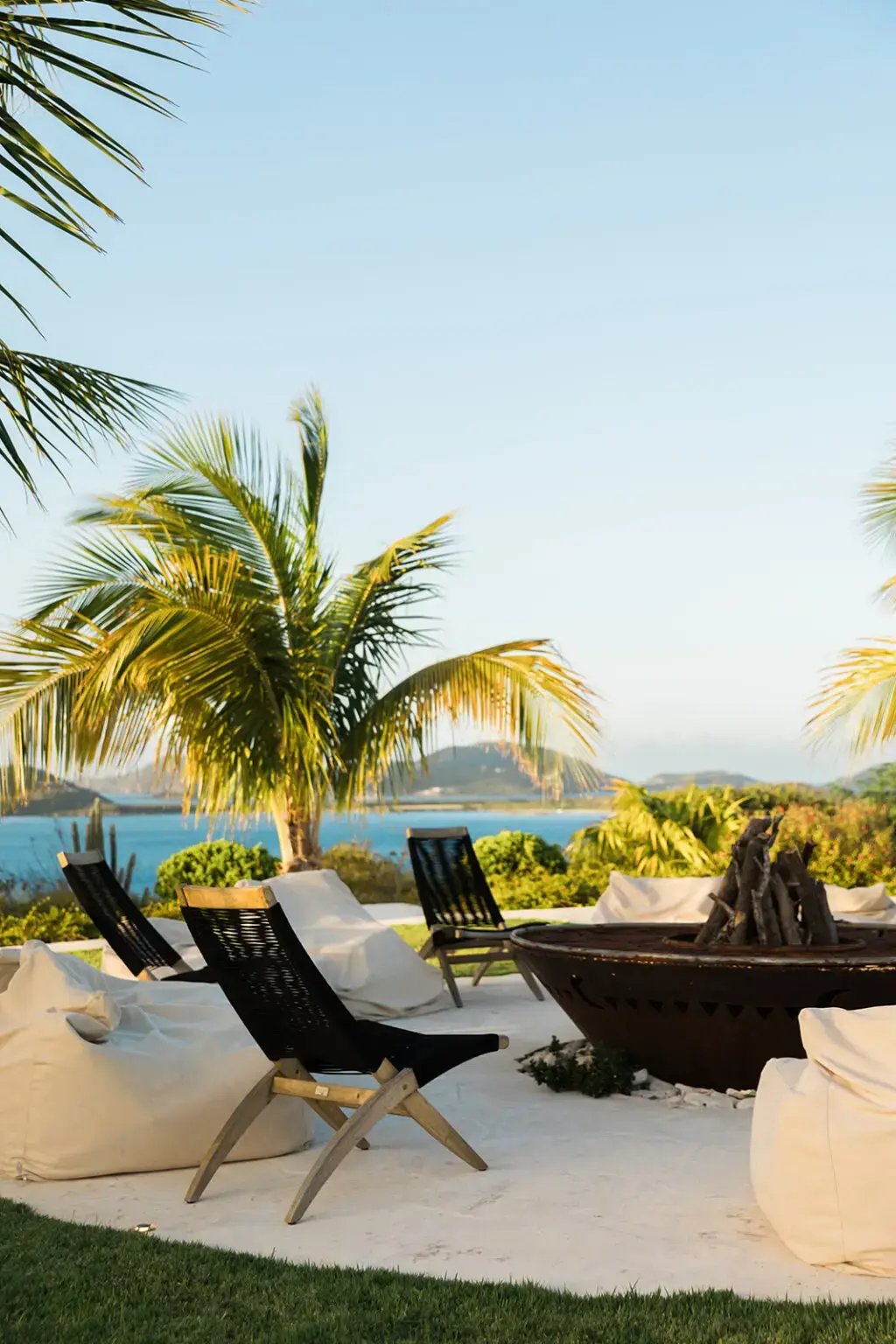 Lounge seating area with palm trees overlooking the ocean at The Aerial, BVI
