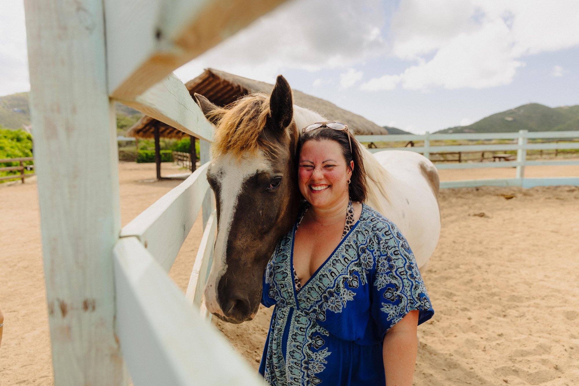 Guest bonding with a rescued horse in the paddock at Redemption Ranch, The Aerial BVI