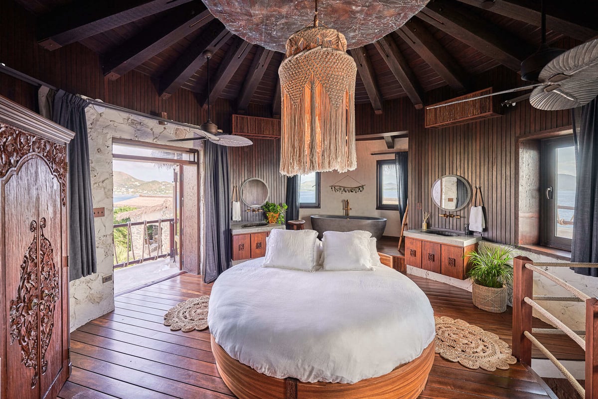 Round bed and open bathroom in a guest room at The Aerial, BVI