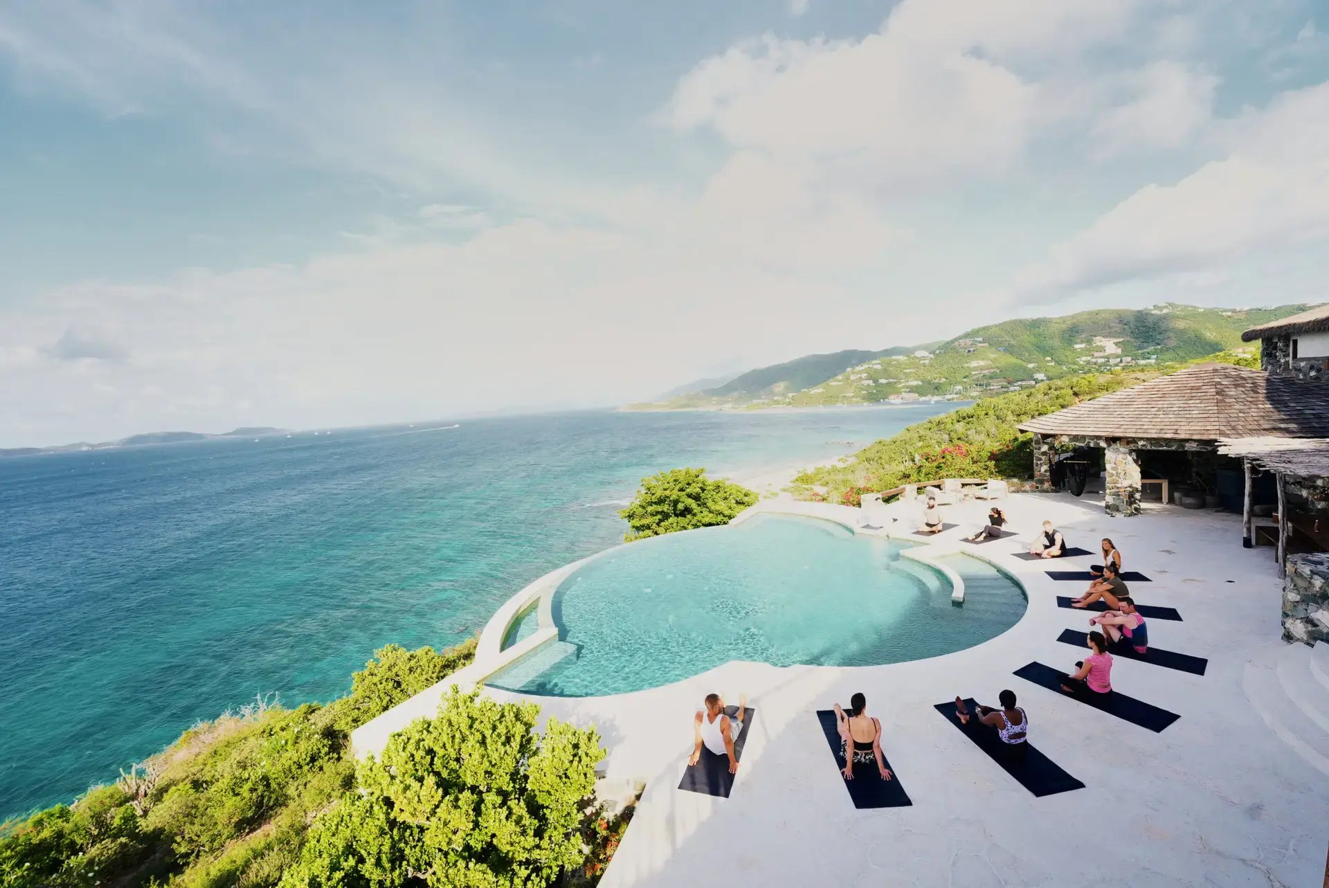 Group guided stretching session by the infinity pool at The Aerial, BVI