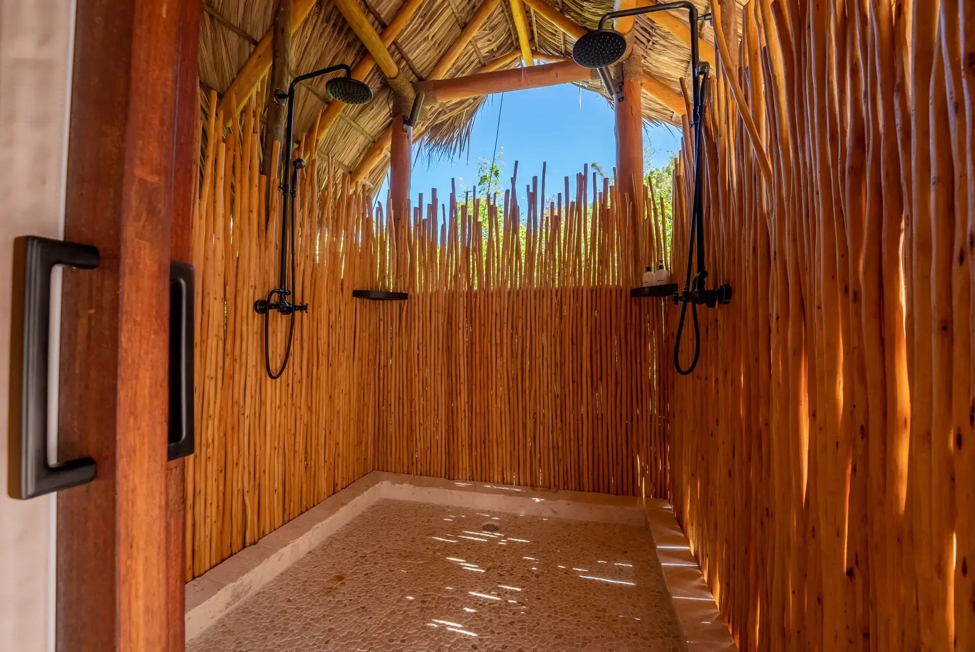 Open-air thatched-roof shower at the spa at The Aerial BVI