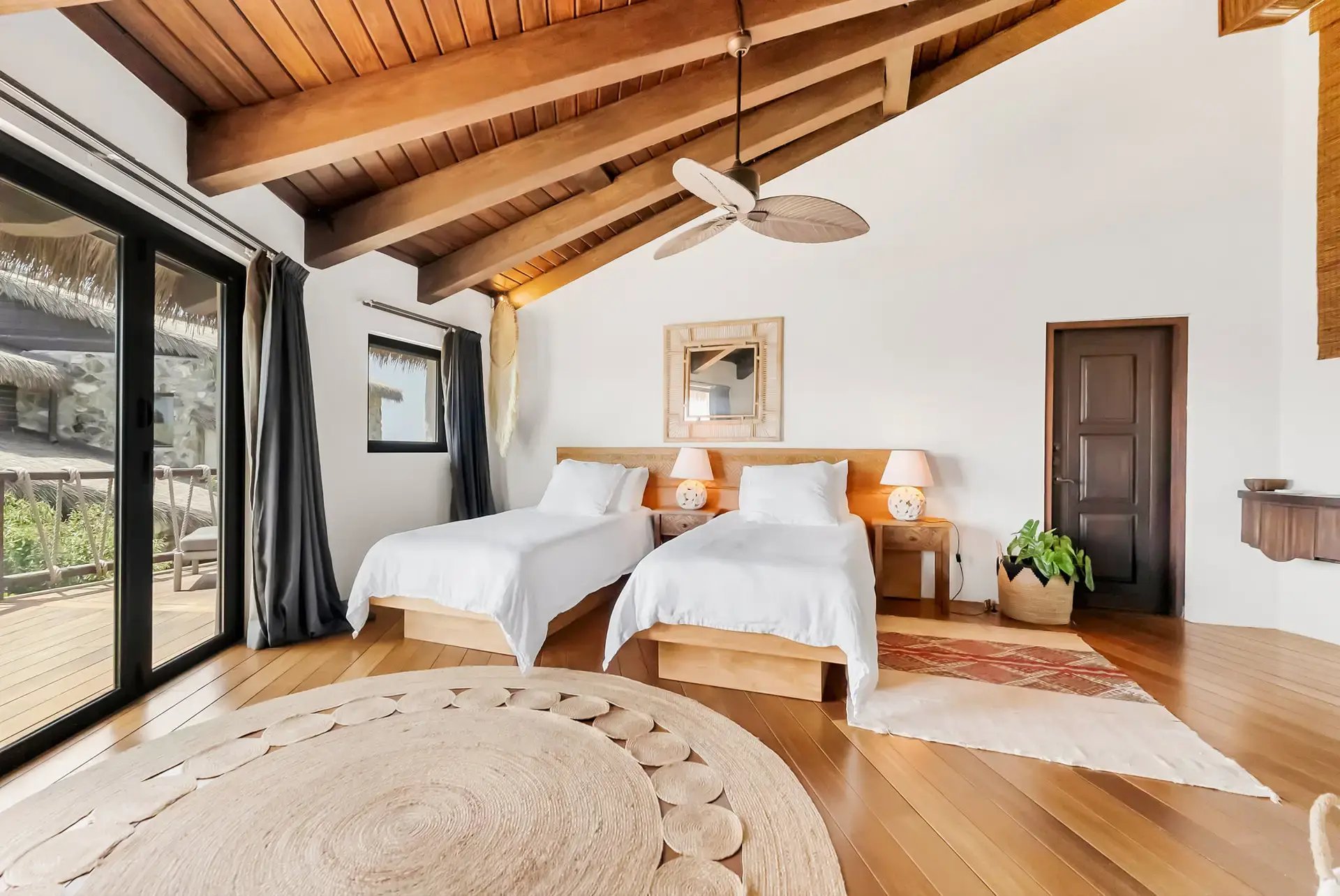 Twin bedroom with sliding glass doors opening to a terrace.