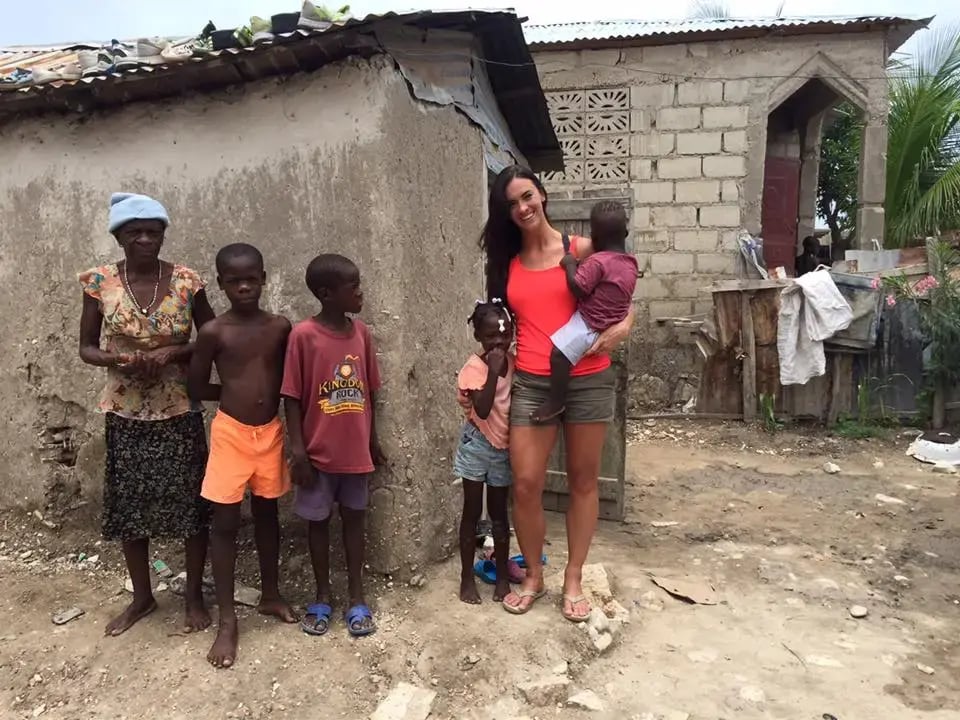 Britnie Turner with children during early mission work in Haiti