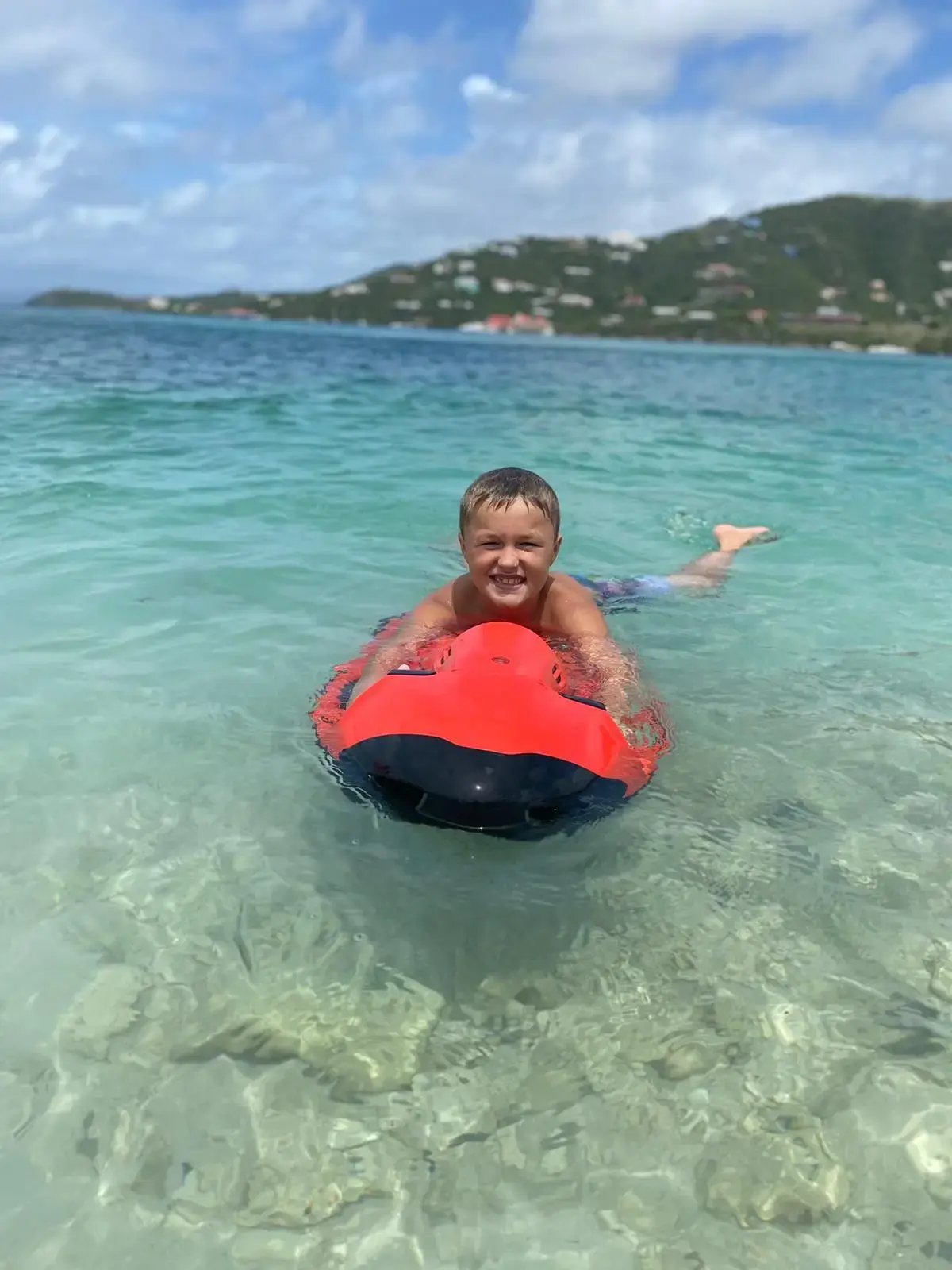 Child floating on an inner tube in the water at The Aerial BVI