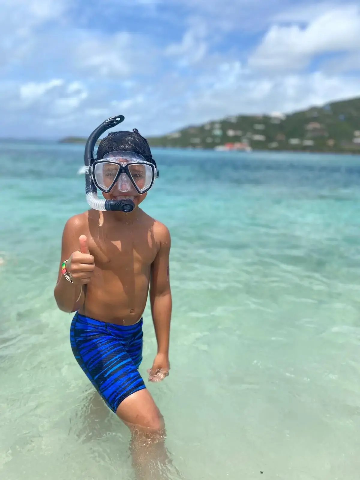 Child in snorkel mask standing in shallow water at The Aerial BVI