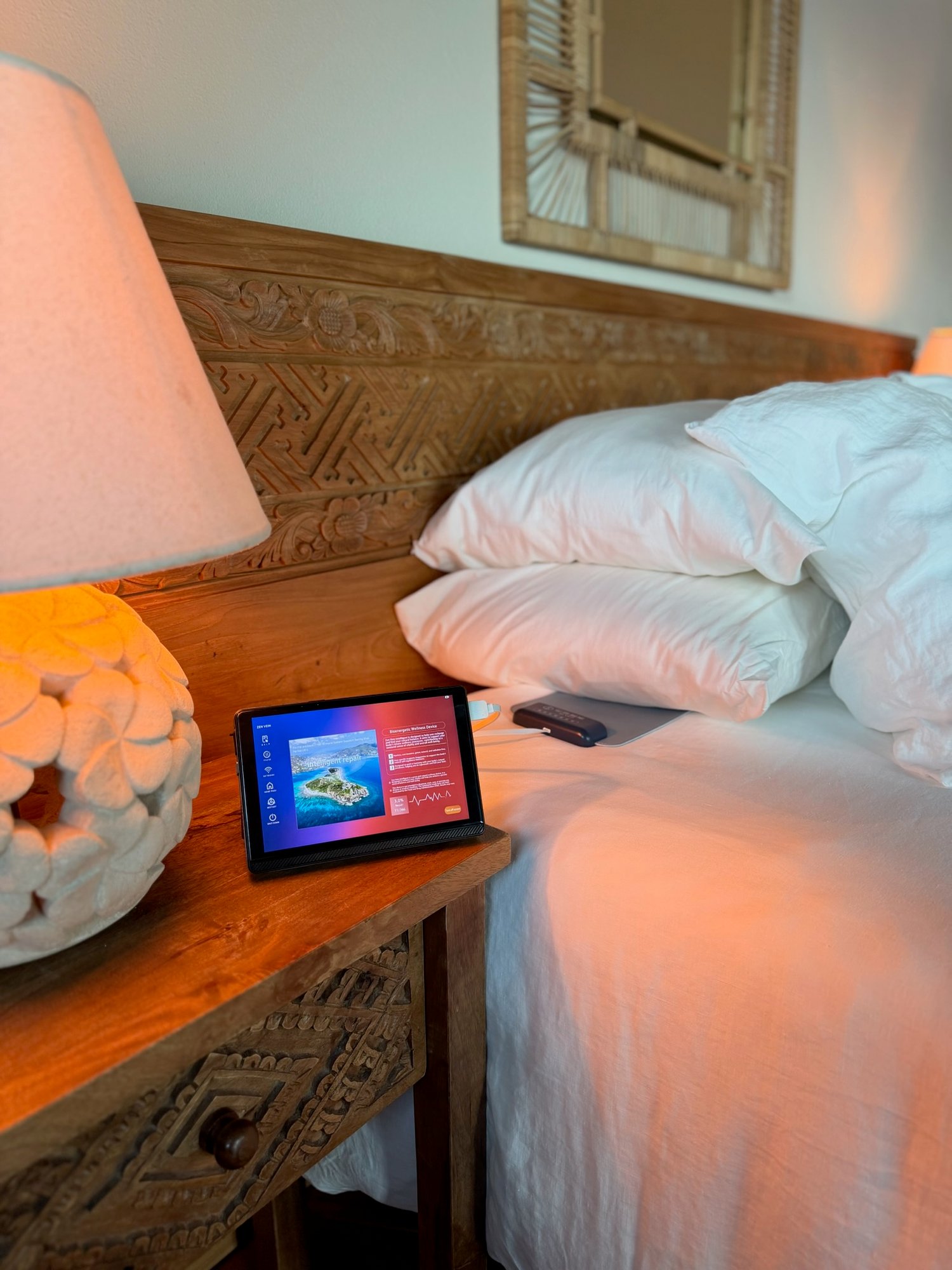 Bed with plush pillows and a wellness tablet display for Zen Vein at The Aerial, BVI.