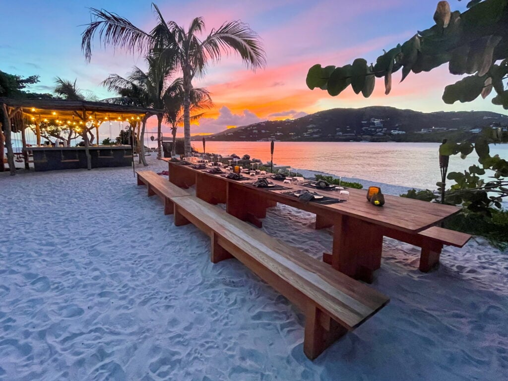 Beachside dining table set for sunset at The Aerial BVI