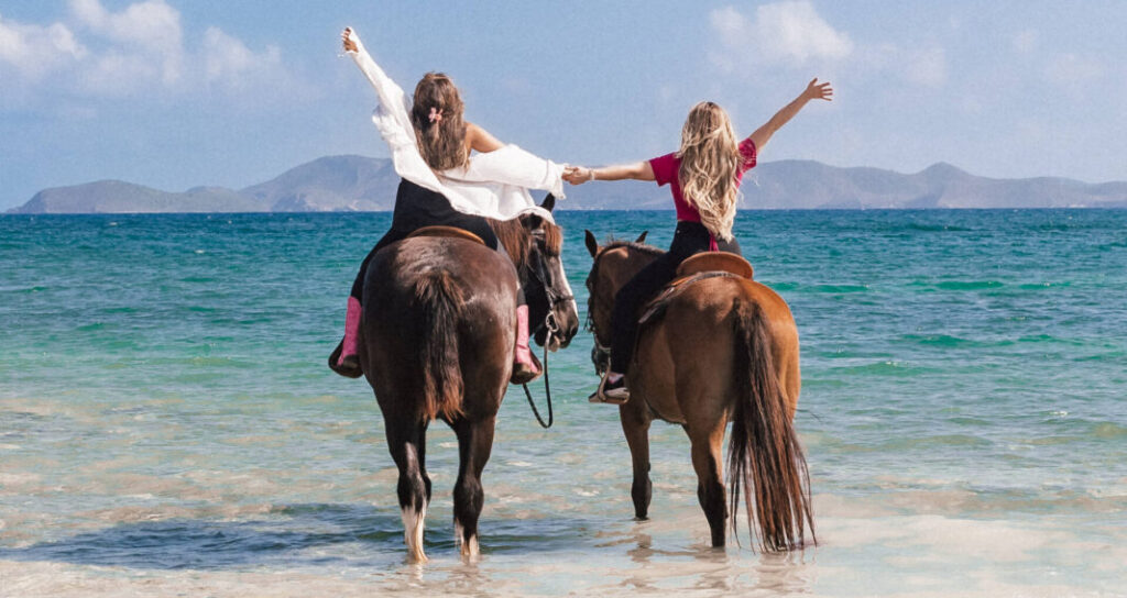 Guests horseback riding in the water at Redemption Ranch, The Aerial, BVI