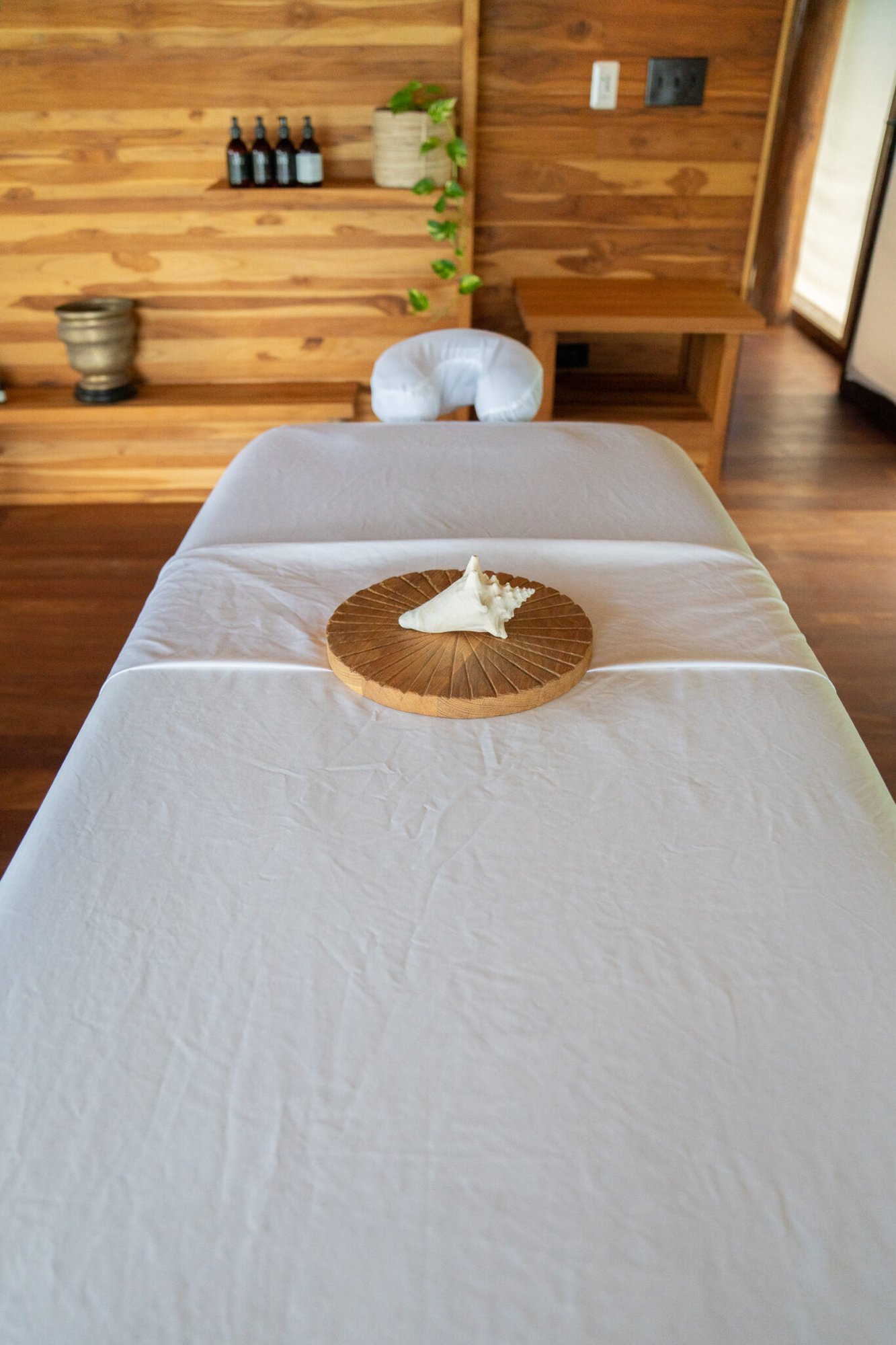 Massage table set with a decorative shell at the spa at The Aerial BVI
