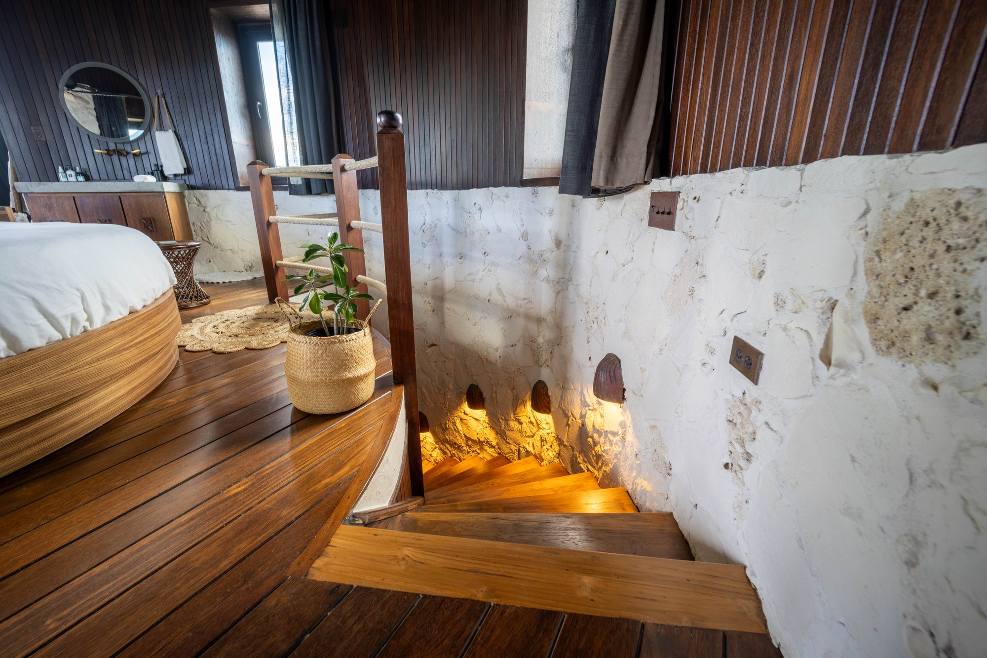 Spiral staircase leading down from a round bed loft at The Aerial, BVI