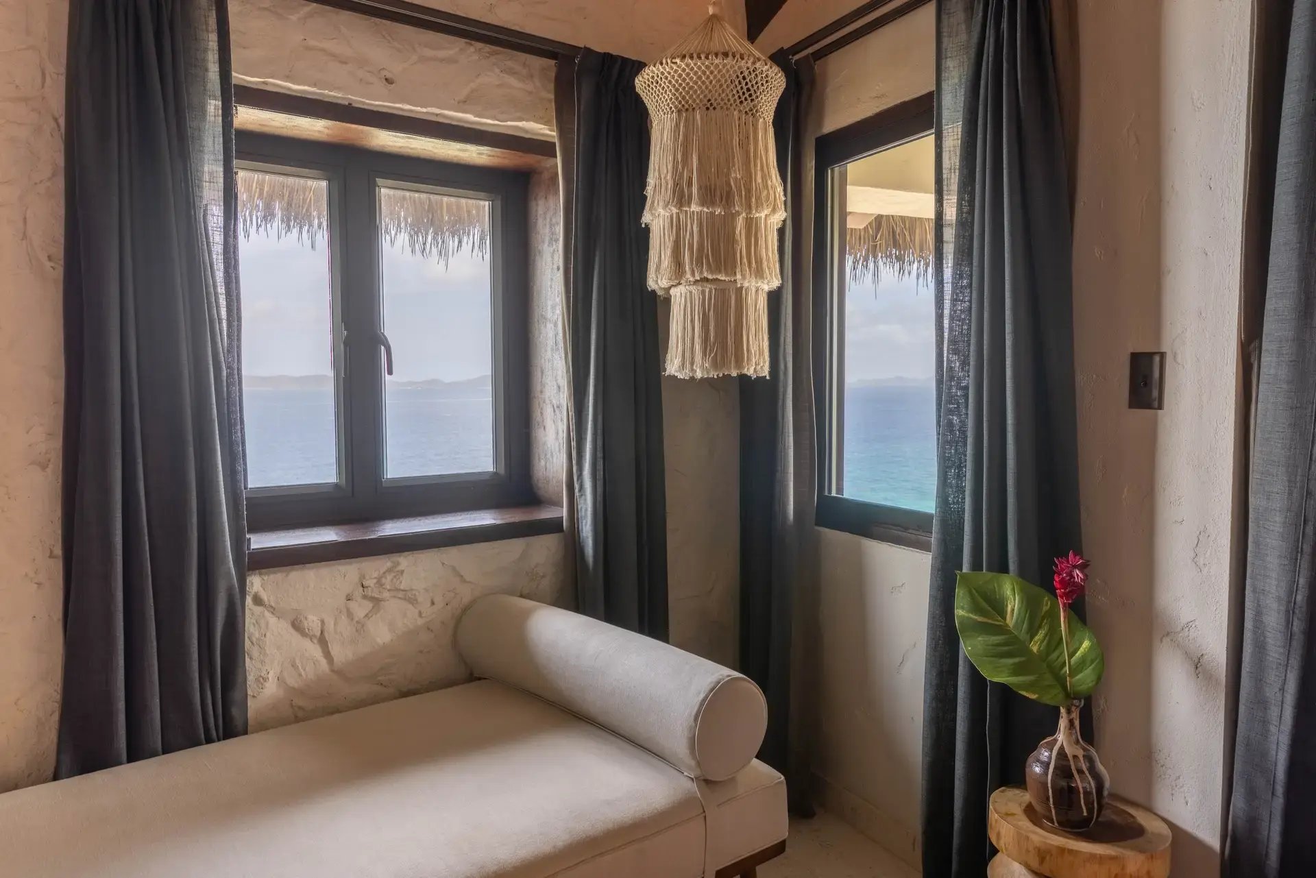 Daybed nook with macrame chandelier and ocean-view windows at The Aerial, BVI