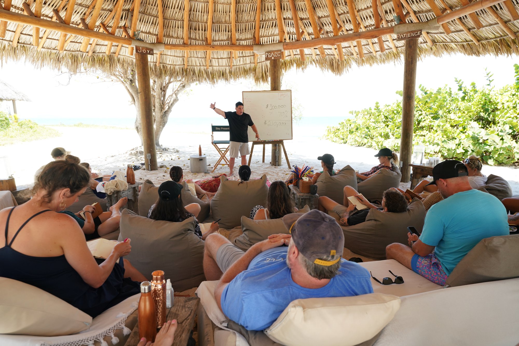 Speaker presenting to a seated group under a pavilion at The Aerial BVI
