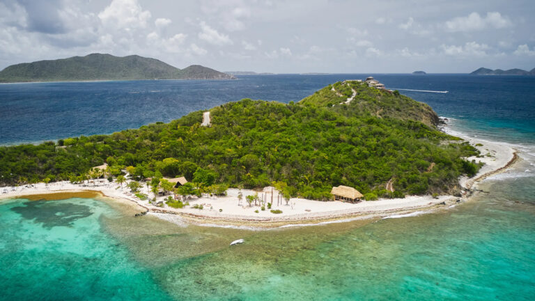 Aerial view of a green island surrounded by turquoise water