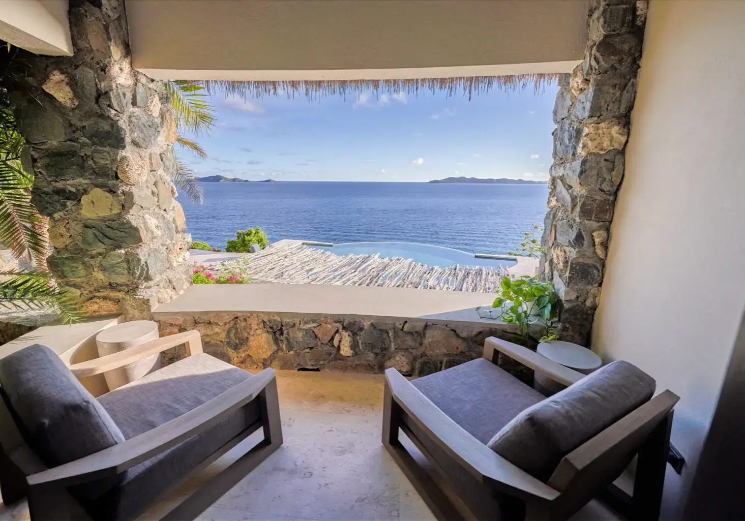 Ocean view through a stone-framed veranda seating area at The Aerial, BVI