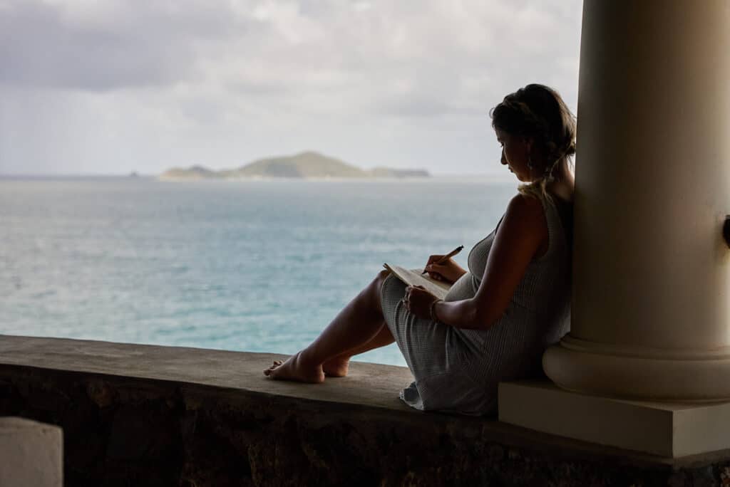 woman journaling on a beach