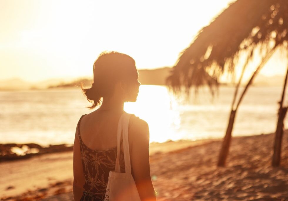 young-asian-woman-walking-on-beach-sunset-64678f19bb97b